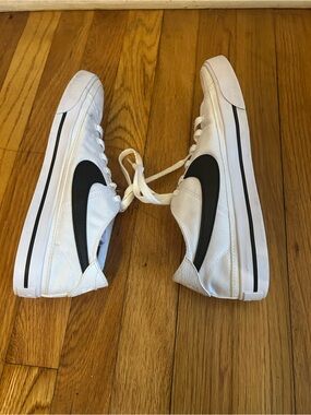 Nike women’s White Canvas Sneakers with Black Swoosh Accent